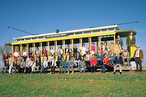 GOMACO’s office staff and plant managers pose for a picture in November 1983 aboard the new trolley for Lowell, Massachusetts
