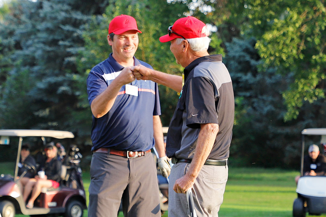 Neil Galloway, Island Slipform Ltd., congratulates teammate Neil MdFadden, Smith Paving & Excavating, in the Contractors' Shoot-Out.