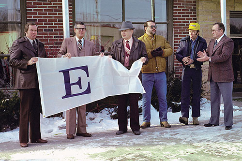 The “E” Award flag was raised during a ceremony in front of GOMACO headquarters in February 1980
