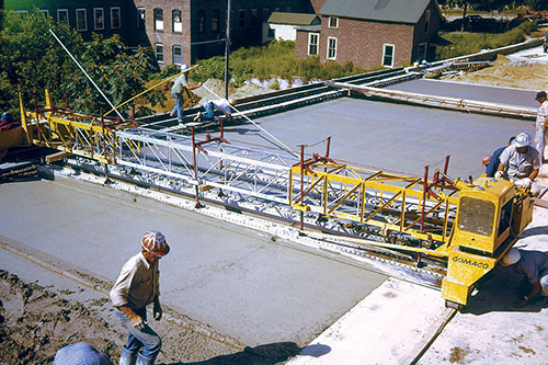 GOMACO's first three original products were the RC-120 side-discharge conveyor, the F-500 double-oscillating screed finisher, and the Spanit Work Bridge