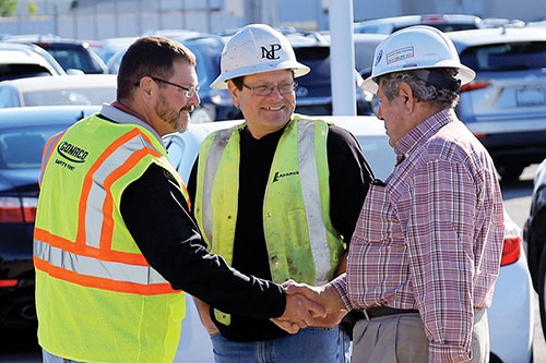 Travis Brockman, GOMACO’s District Manager for the Northeast and Canada, Mario and Nick Piccoli, owners of Piccoli Construction